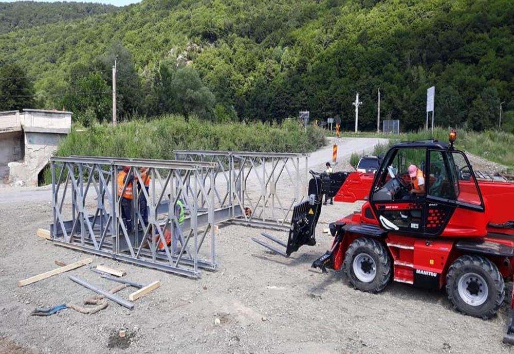 FOTO | Au început lucrările de instalare a unui pod metalic provizoriu pe Drumul Apusenilor, în localitatea Valea Drăganului